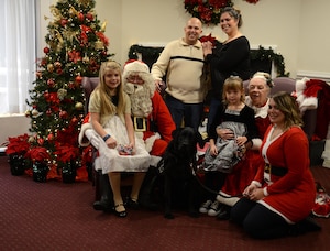 U.S. Army Sgt. Matt Johns, 221st Military Police Detachment officer, his family and his daughter’s service dog, Hope, take a photo with Santa and Mrs. Claus during the brunch with Santa event at Joint Base Langley-Eustis, Va., Dec. 4, 2016. Each year, Santa and Mrs. Claus take time out of their holiday schedule to meet with children at various events on the installation. (U.S. Air Force photo by Staff Sgt. Teresa J. Cleveland)
