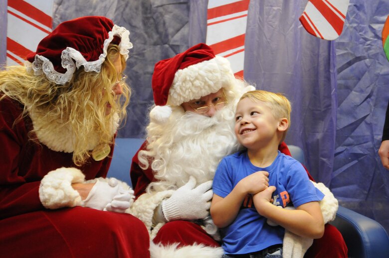 Jackson Rosenfeldt shares his Christmas wishes with Santa and Mrs. Claus during the 2016 Candy Land Children’s Holiday Fest at Schriever Air Force Base, Colorado, Saturday, Dec. 3, 2016. The free Santa experience saved families trips into town to meet Santa. (U.S. Air Force photo/1st Lt. Darren Domingo)