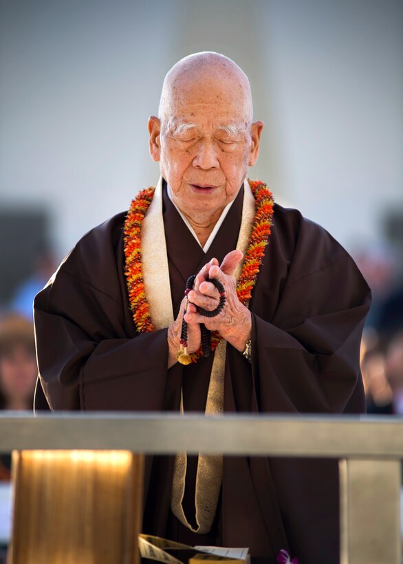 Bishop Ryokan Ara of the Tendai Mission in Honolulu, Hawaii, delivers a blessing during the 6th annual Blackened Canteen ceremony at the USS Arizona Memorial during the 75th commemoration of the attacks on Pearl Harbor, Hawaii, Dec. 6, 2016. Navy photo by Petty Officer 2nd Class Somers Steelman