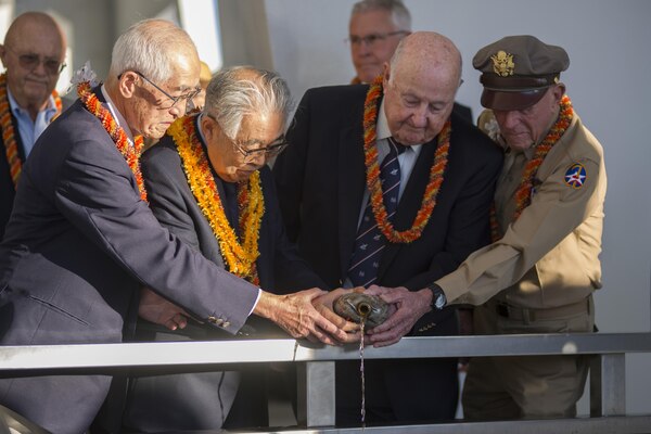 Shiro Wakita, left, former WWII Imperial Japanese Navy pilot; Dr. Hiroya Sugano M.D, center left, director general of the Zero Fighter Admirers Club; Jack Detour, center right, former colonel and WWII Army Air Force B-25 pilot; and Jerry Yellin, right, former captain and WWII Army Air Force P-51 pilot, pour bourbon whiskey at the 6th annual Blackened Canteen ceremony at the USS Arizona Memorial during the 75th Commemoration of the attacks on Pearl Harbor in Pearl Harbor, Hawaii, Dec. 6, 2016. Navy photo by Petty Officer 2nd Class Somers Steelman
