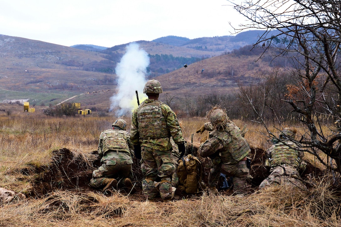 A soldier throws a grenade while participating in a live-fire exercise during Exercise Mountain Shock at Pocek Range in Slovenia, Dec. 5, 2016. Army photo by Davide Dalla Massara