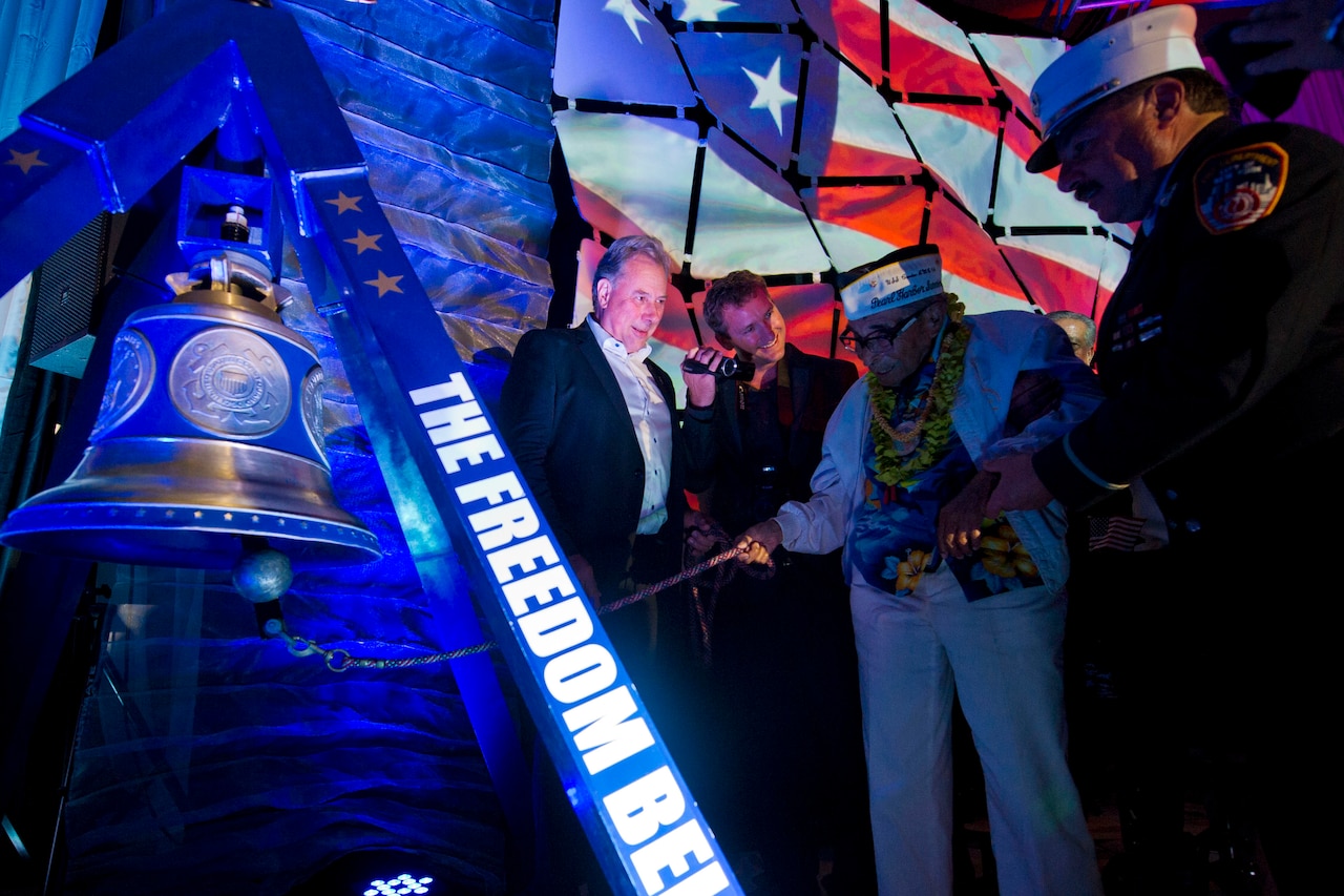 Ray Chavez, the oldest living World War II veteran at age 104, rings the "Freedom Bell" at the "December 7th Remembered" gala honoring Pearl Harbor survivors and World War II veterans in Honolulu, Dec. 6, 2016. The bell, which is displayed in various cities, was cast in bronze with steel from the Twin Towers. DoD photo by Lisa Ferdinando