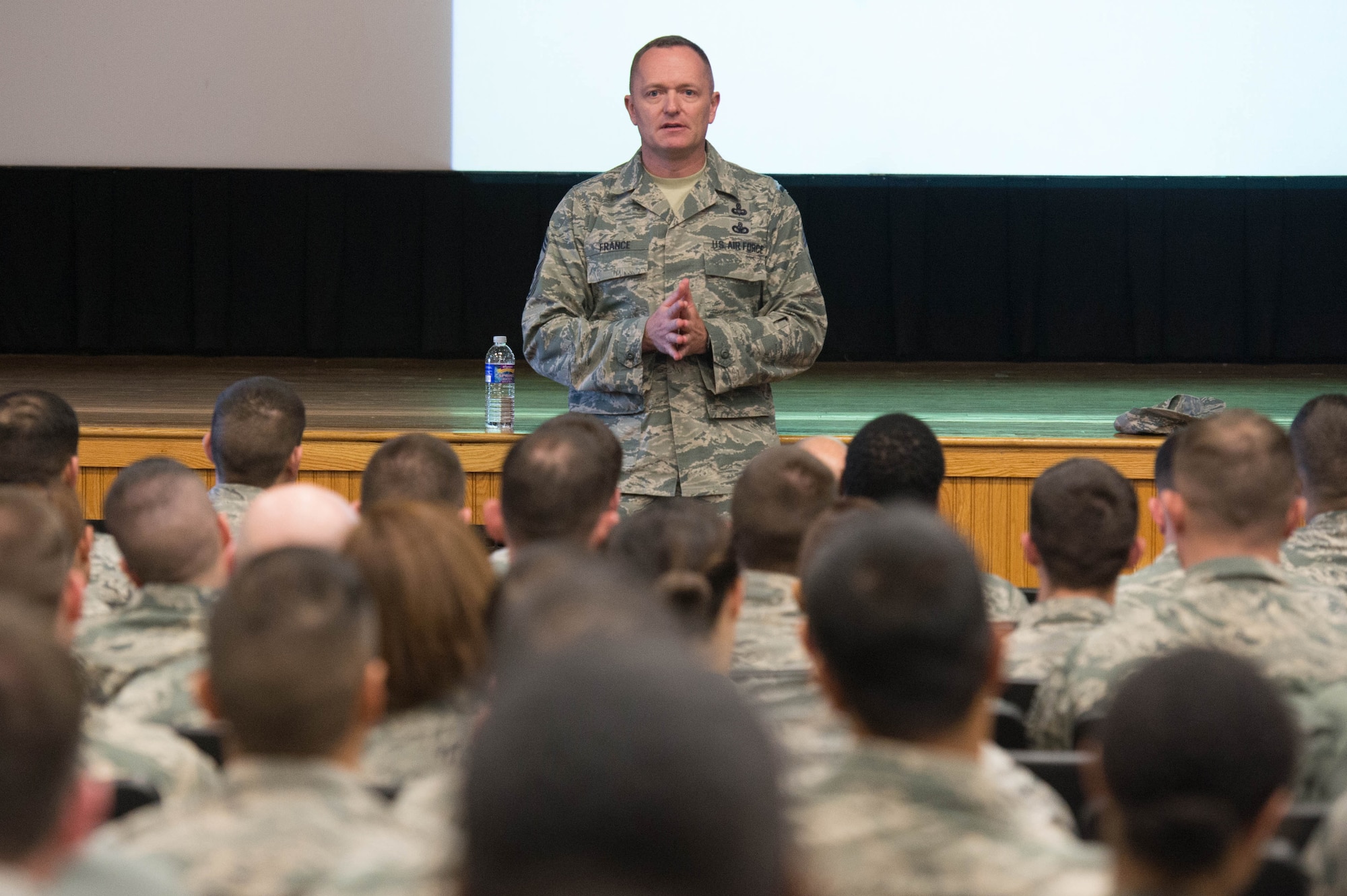 Command Chief Master Sgt. Jason France, Air Force Materiel Command's command chief, talks with Airmen during an Enlisted Call at the base theater Dec.1. During the one-hour session, the command's senior enlisted member shared his thoughts on a number of topics that affect enlisted personnel. (U.S. Air Force photo by Jerry Saslav)