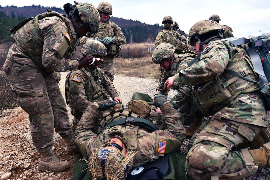 Soldiers provide medical aid to simulated wounded patient while conducting a live-fire exercise during Exercise Mountain Shock at Pocek Range in Slovenia, Dec. 5, 2016. Army photo by Davide Dalla Massara