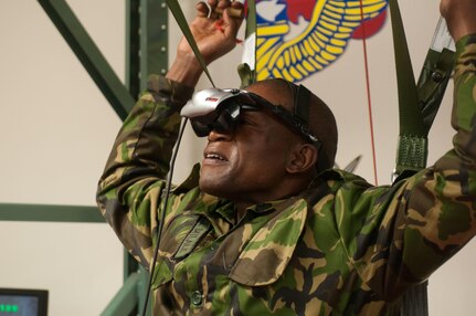 Sgt. Lentikile Dittale representing the Botswana Special Forces Regiment prepares to use the U.S. steering parachute simulator to familiarize himself before participating Operation Toy Drop XIX. Operation Toy Drop is an annual collective training exercise used to prepare Soldiers to support the Global Combatant Commanders and Army Service Component Commanders in theaters of operation around the world. (U.S. Army Reserve Photo by Spc. Tynisha L. Daniel)