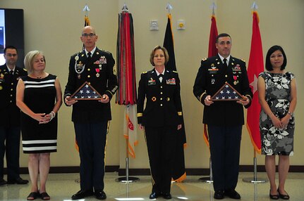 (From Left to Right Dana Klikas, Sgt. Maj. Paul J. Klikas, Maj. Gen. Megan Tatu, Col. Charles E. Newbegin and Hyon Newbegin) Sgt. Maj. Paul J. Klikas and Col. Charles E. Newbegin stand together after being presented their U.S. Flags July 22, 2016 at Marshall Hall, Fort Bragg, N.C. as part of their retirement celebration. (U.S. Army photo by Pfc. Hubert D Delany III)