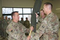 (Left) Lt. Col. Ryan Melby, commander of the 3rd Battalion, 399th Regiment, receives the encased battalion colors from Col. Bradly Boganowski, commander of the 800th Logistics Support Brigade, at the battalion's deactivation ceremony as 1st Sgt. Michael Olson, the battalion's first sergeant, looks on. The deactivation was held at the Army Reserve Center in Sturtevant, Wis., Dec. 3, 2016.