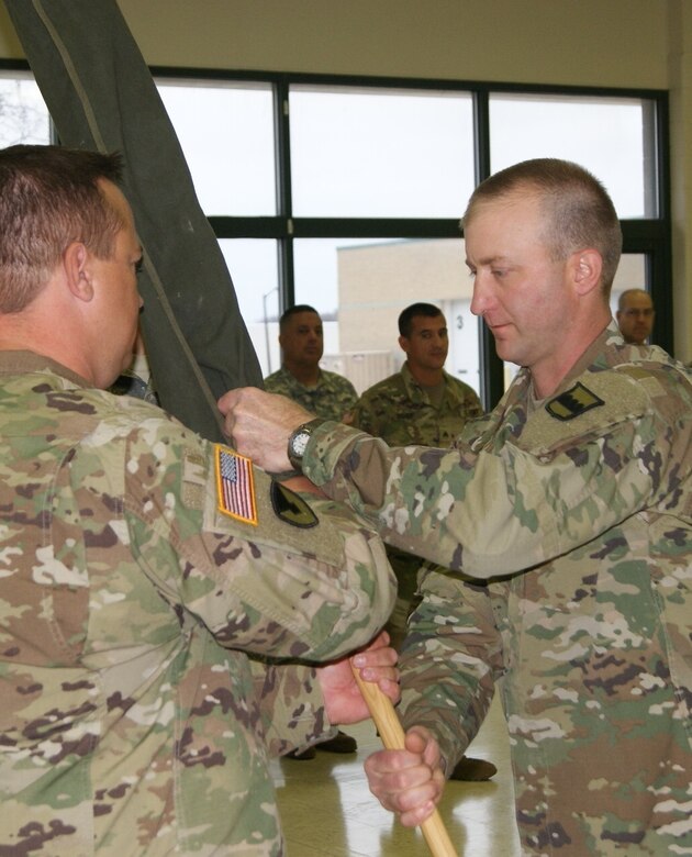 (Left) Lt. Col. Ryan Melby, commander of the 3rd Battalion, 399th Regiment, passes the encased battalion colors to 1st Sgt. Michael Olson, the battalion's acting command sergeant major, at the unit's deactivation ceremony held at the Army Reserve Center in Sturtevant, Wis., Dec. 3, 2016.