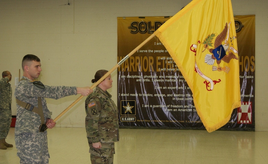 (Right) Maj. Jennifer Wagner, 3rd Battalion, 399th Regiment commander of troops, leads Sgt. Scott Schultz, flag bearer, and her formation to present arms during the playing of the National Anthem at the battalion's deactivation ceremony at the Army Reserve Center in Sturtevant, Wis., Dec. 3, 2016.