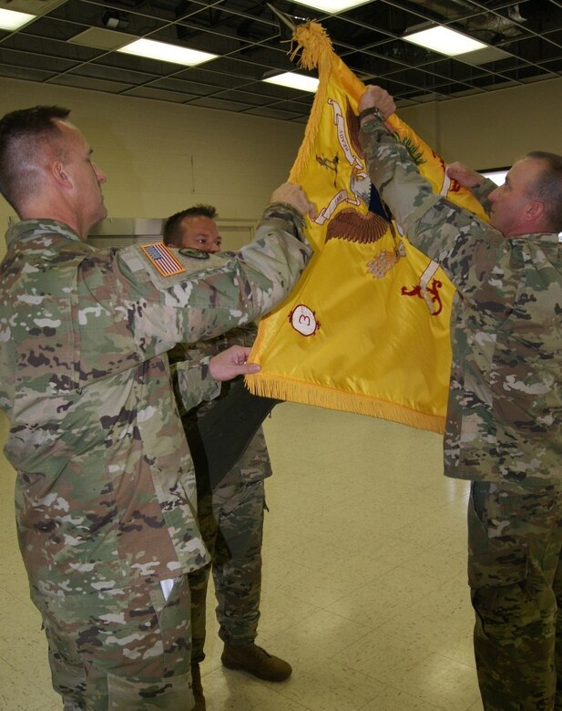(Left) The 800th Logistics Support Brigade Commander Col. Bradly Boganowski and 1st Sgt. Michael Olson, acting command sergeant major of the 3rd Battalion, 399th Regiment, (right) furl the flag at the battalion's deactivation ceremony as Lt. Col. Ryan Melby, 3rd Battalion commander, (center) waits to encase the flag. The ceremony was held at the Army Reserve Center in Sturtevant, Wis., Dec. 3, 2016.