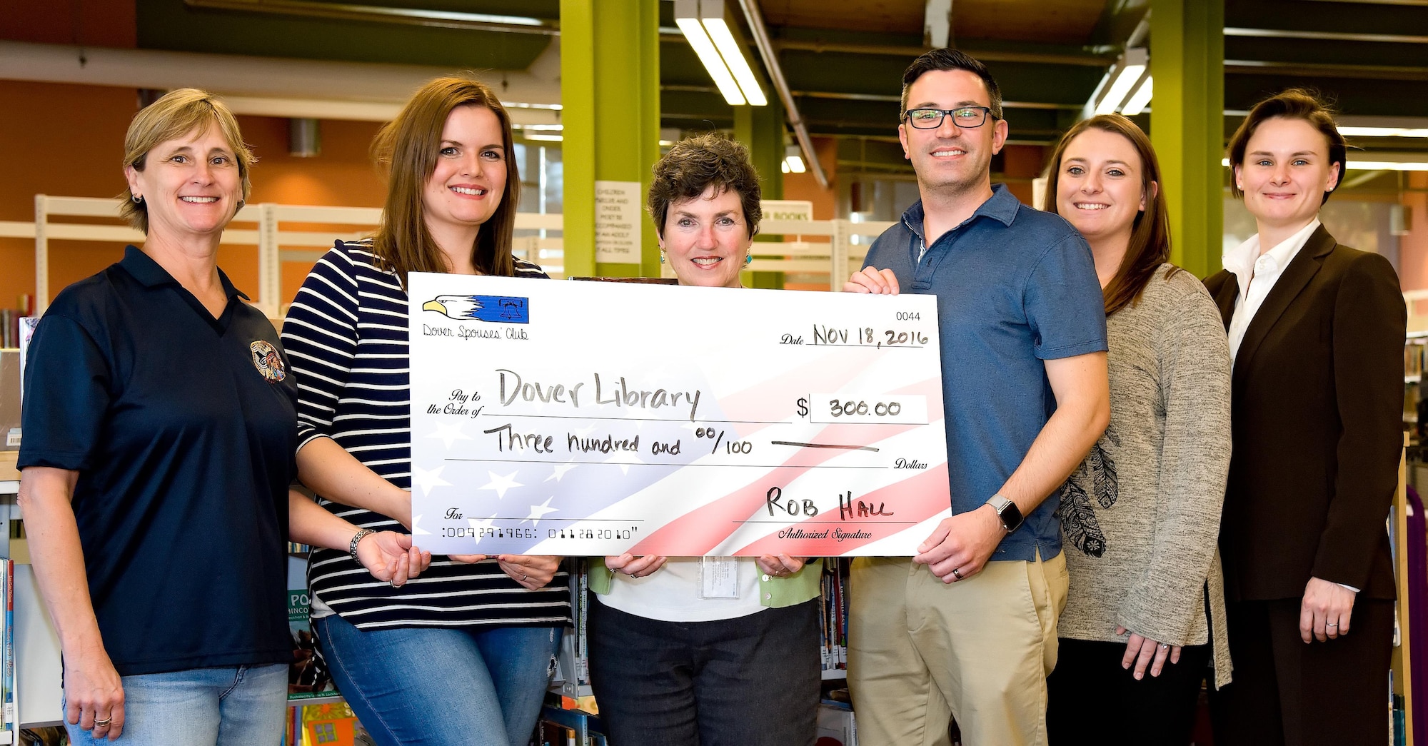 Rob Hall, Dover Spouses’ Club president, presents a check for $300 to Margie Cyr, Dover Public Library director, Nov. 18, 2016, at the Dover Public Library, Dover, Del. The check was donated to the Dover Library Foundation. Pictured left to right, Debra Liles, DSC vice president; Kendall Gann, DSC social chair; Cyr; Hall; Zelia Little, DSC secretary; and Ashley Gutermuth, DSC member. (U.S. Air Force photo by Roland Balik)
