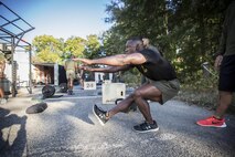 A Force Fitness Instructor Trainer demonstrates the proper execution of a pistol squat. While attending the course, students will learn how to perform and coach a variety of exercises and movements.