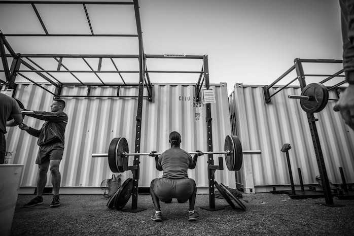 An FFI student performs a front squat, emphasizing proper form and depth. While attending the course, students will learn how to properly correct deficiencies while performing exercises.