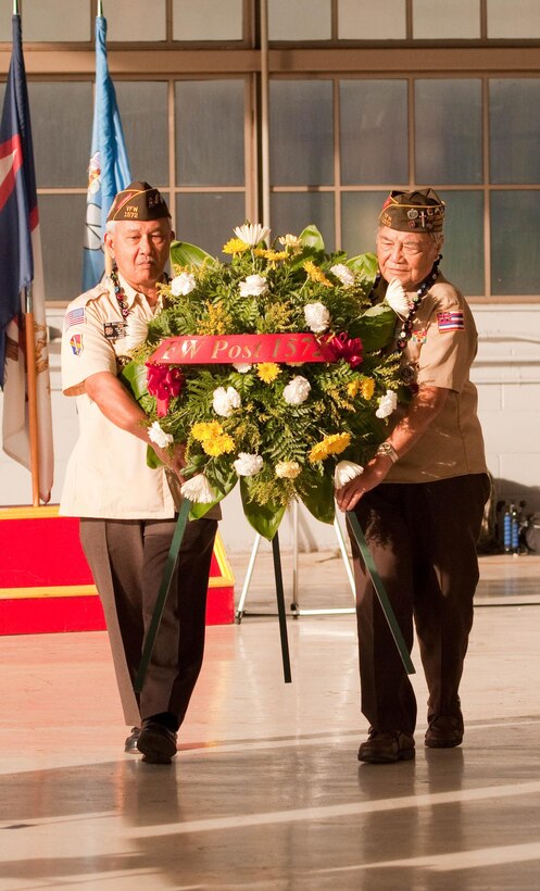 Ray D. Ballungay and Abilino Bagayas, members of the Veterans of Foreign Wars Post 1572, present a wreath during the Wheeler Field Remembrance, in Hangar 206 at Wheeler Army Airfield, Hawaii, Dec. 5, 2016. The ceremony commemorated the 75th anniversary of the attacks on Wheeler Field, Dec. 7, 1941. Army photo by Kristen Wong
