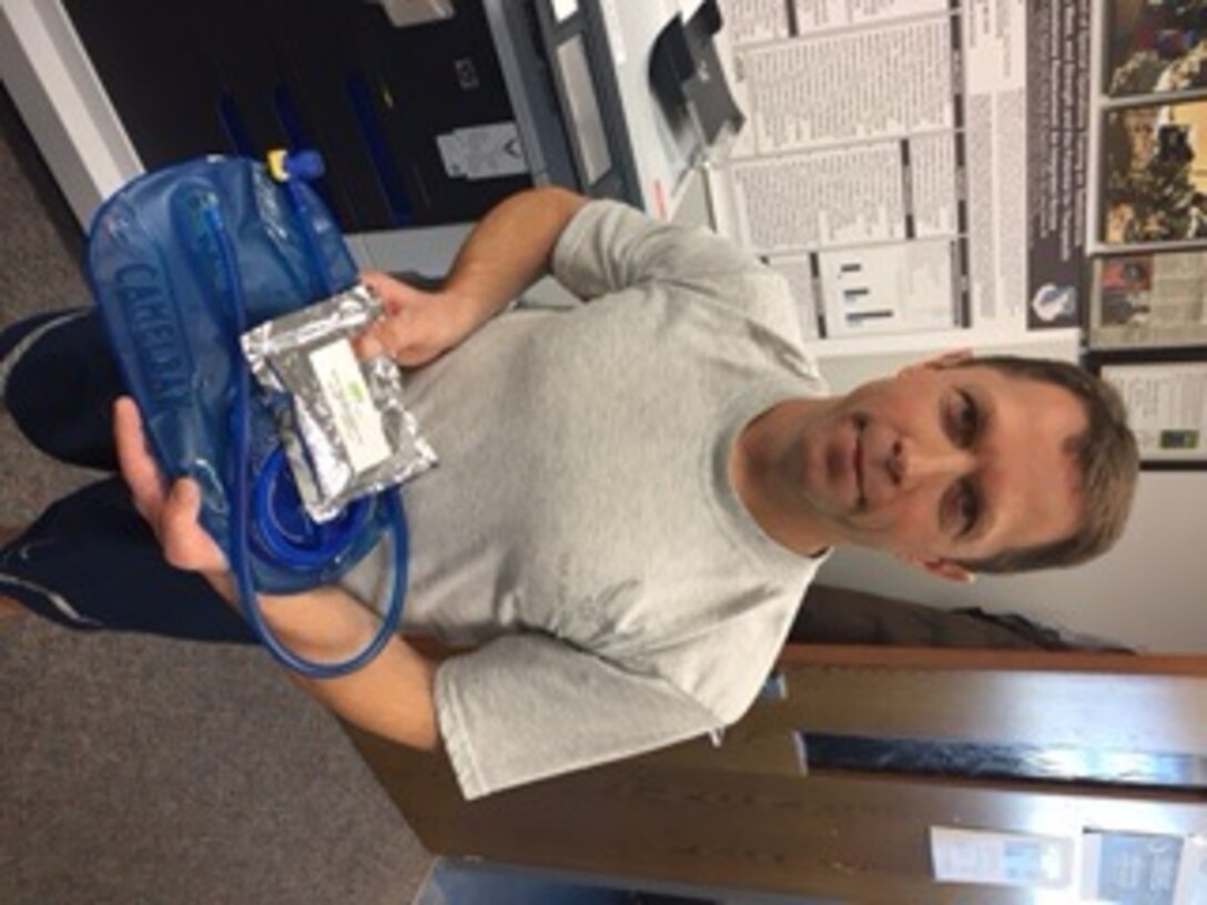Col. Kirk Winger, 88th Aerospace Medicine Squadron commander, holds a CamelBak® hydration system used in rucksacks and a powder supplement. (U.S. Air Force courtesy photo)
