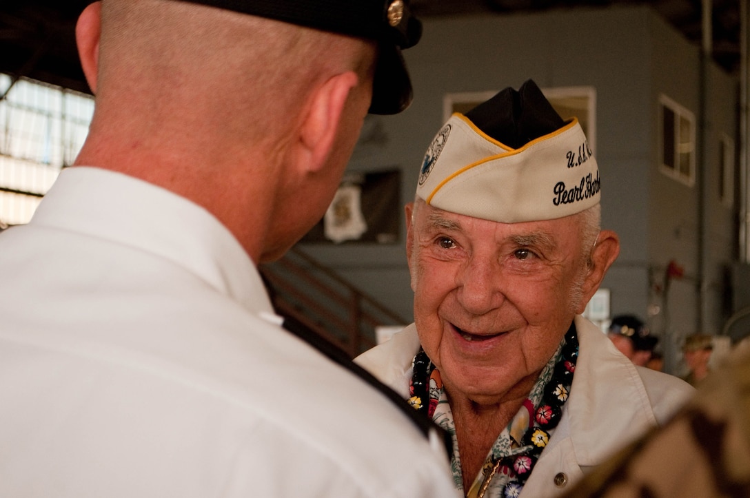 Army Maj. Gen. Christopher G. Cavoli, left, commander, 25th Infantry Division, talks with World War II veteran Clarence Byal, after the Wheeler Field Remembrance, in Hangar 206 at Wheeler Army Airfield, Hawaii, Dec. 5, 2016. Byal was stationed aboard the USS St. Louis in World War II. Army photo by Kristen Wong