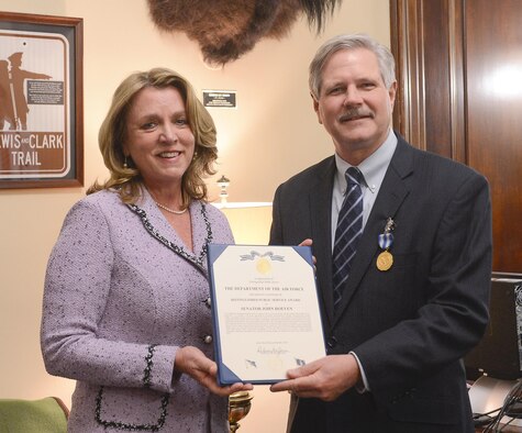 Air Force Secretary Deborah Lee James presents the Distinguished Public Service Award to U.S. Sen. John Hoeven (R-ND), in Washington, D.C. Dec 6, 2016. Hoeven introduced legislation that set up six remotely piloted vehicle test sites, including one at Grand Forks Air Force Base, North Dakota. (U.S. Air Force photo/Andy Morataya)