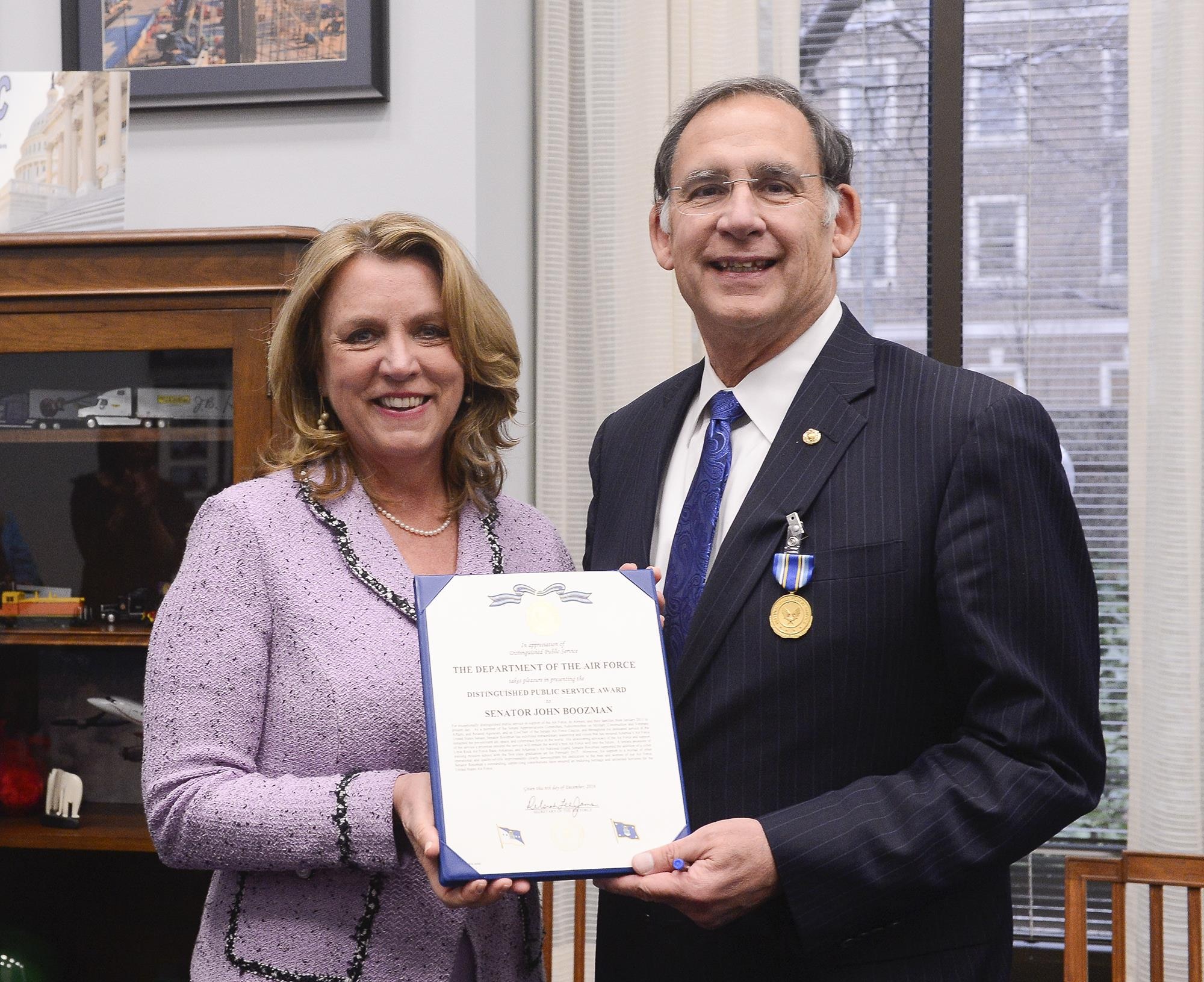 Air Force Secretary Deborah Lee James presents the Distinguished Public Service Award to U.S. Sen. John Boozman (R-AR), in Washington, D.C. Dec 6, 2016. Boozman supported the addition of a cyber training mission school at Little Rock Air Force Base, Arkansas. The first class graduation scheduled for February 2017. (U.S. Air Force photo/Andy Morataya)