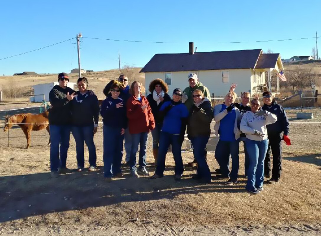 The staff from HQ RIO Detachment 3, Peterson Air Force Base, Colorado, volunteered at the Pikes Peak Therapeutic Riding Center, Nov. 30. Pictured here from left to right are: Staff Sgt. Nikolaus Rouse, Senior Airman Gabrielle Loera, Senior Master Sgt. Karen Rouse, Master Sgt. Raul Gonzalez, Senior Master Sgt. Ruth Altman-Burnett, Alba Palacio, Staff Sgt. Gomez, Kurt Grogan, Carri Boswell, Col. Jennifer McGonigle, Senior Master Sgt. Tiffany Maine, Master Sgt. Tonge, Senior Master Sgt. Sonia Balas
