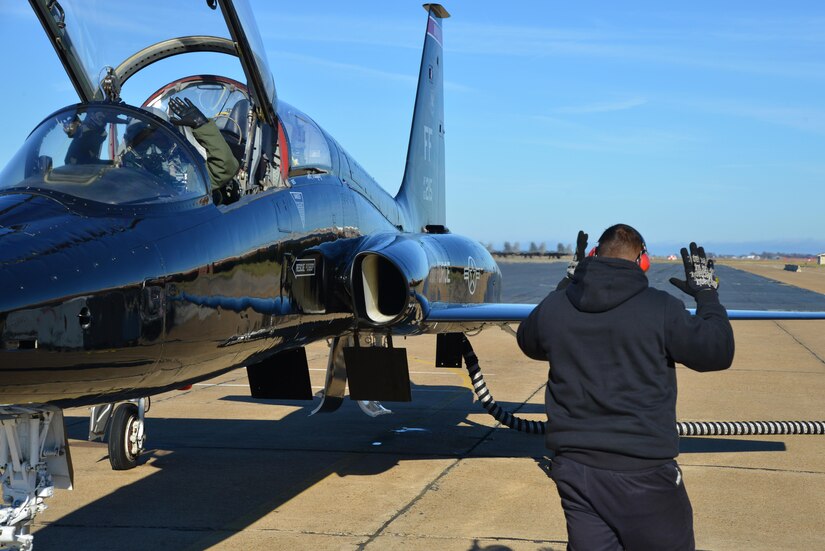 Orlando Vasquez, Mission 1st Support Services contractor, performs pre-flight checks with U.S. Air Force Capt. Chelsea Bailey, 71st Fighter Training Squadron T-38 Talon adversary air mission commander, at Joint Base Langley-Eustis, Va., Dec. 6, 2016. Members of the Mission 1st Support Services are crew chiefs, who also have additional roles such as electricians, structural mechanics and environmental. (U.S. Air Force photo by Airman 1st Class Tristan Biese)