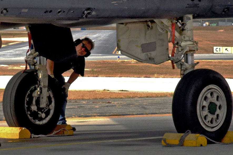 A Team Robins member inspects the F-15 flown to Robins from Seymour Johnson Air Force Base, North Carolina, by 4th Fighter Wing Commander Col. Christopher Sage. Robins is responsible for programmed depot maintenance on F-15s, proving that Success Here = Success There! (U.S. Air Force photo by Ed Aspera)
