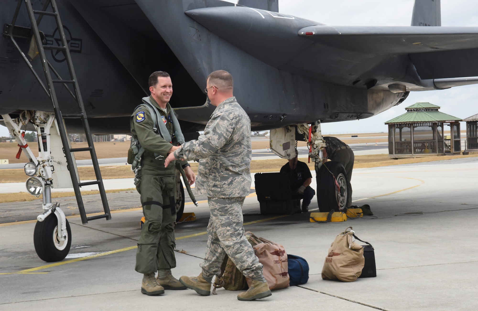 Brig. Gen. John Kubinec, Warner Robins Air Logistics Complex commander, greets Col. Christopher Sage, 4th Fighter Wing commander, following Sage's flight from Seymour Johnson Air Force Base, North Carolina. The F-15 Strike Eagle is at Robins Air Force Base for Programmed Depot Maintenance. (U.S. Air Force photo by Ed Aspera)