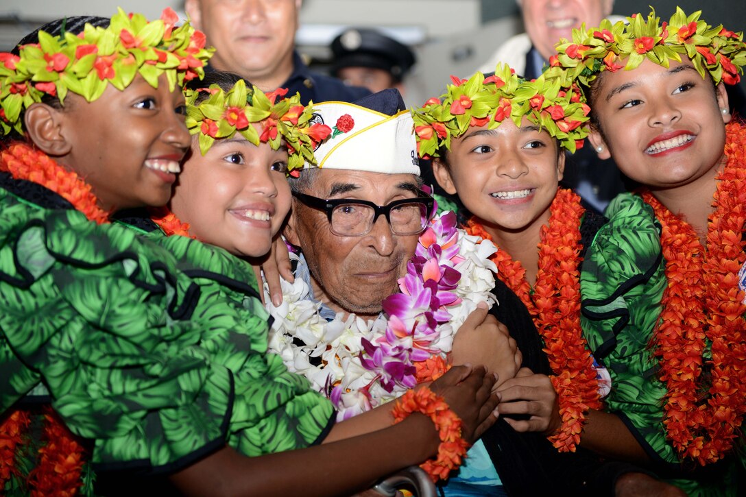 Ray Chavez, a 104-year-old Navy veteran and the oldest surviving Pearl Harbor veteran, poses for a photograph after being greeted by several military members and personnel at the Honolulu International Airport, Dec. 3, 2016. More than 100 World War II veterans, including Pearl Harbor survivors, arrived to Honolulu to participate in the remembrance events throughout the week to honor the courage and sacrifices of those who served during Dec. 7, 1941, and throughout the Pacific Theater. Dec. 7, 2016, marks the 75th anniversary of the attacks on Pearl Harbor and Oahu. Coast Guard photo by Petty Officer 2nd Class Tara Molle