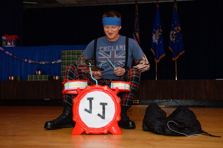 Chaplain (Capt.) Portmann Werner, 50th Space Wing chaplain, drums during a lip-sync performance for the 2016 50 SW holiday party at Peterson Air Force Base, Colorado, Friday, Dec. 2, 2016. The Chapel Office’s performance was a team effort, earning them the reigning championship title two years in a row. (U.S. Air Force photo/Christopher DeWitt)