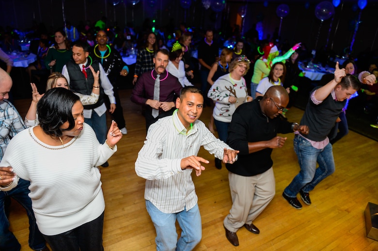 Partygoers dance during the 50th Space Wing’s “Glow in the Snow” Holiday Party at Peterson Air Force Base, Colorado, Friday, Dec. 2, 2016.  The event featured lip-sync battles and other games and prizes for participants. (U.S. Air Force photo/Christopher DeWitt)
