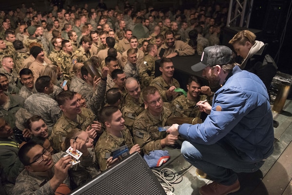 Scarlett Johansson and Chris Evans sign autographs for service members during the USO Holiday Tour at Incirlik Air Base, Dec. 5, 2016. Marine Gen. Joseph F. Dunford, Jr., chairman of the Joint Chiefs of Staff, and USO entertainers, will visit service members who are deployed from home during the holidays at various locations across the globe. This year’s entertainers included actor Chris Evans, actress Scarlett Johansson, NBA Legend Ray Allen, 4-time Olympic Medalist Maya DiRado, Country Music Singer Craig Campbell, and mentalist Jim Karol. (DoD photo by Navy Petty Officer 2nd Class Dominique A. Pineiro)