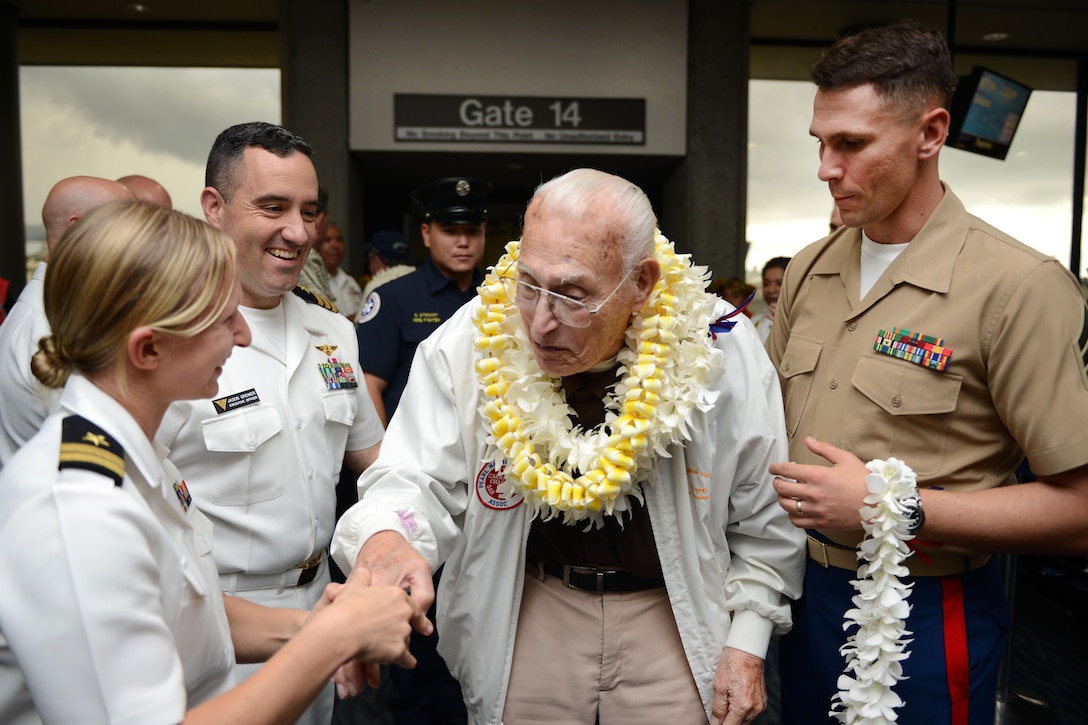 A Pearl Harbor survivor is greeted by service members at the Honolulu International Airport, Dec. 3, 2016. Coast Guard photo by Petty Officer 2nd Class Tara Molle