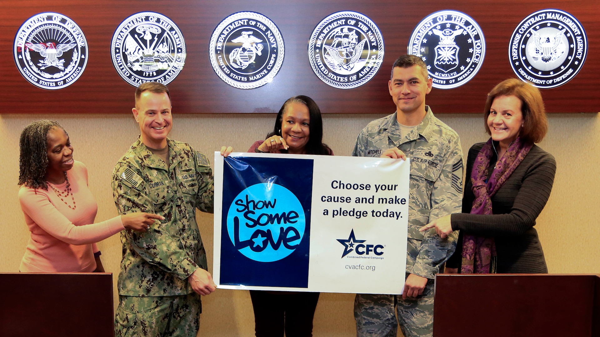 Defense Contract Management Agency team members hold a 2016 Combined Federal Campaign poster Dec. 1 at the agency’s headquarters building on Fort Lee, Virginia. As campaigns draw to a close across the agency, employees are running out of time to choose a charity, make a pledge and show some love. (Photo by Thomas Perry, DCMA Public Affairs)