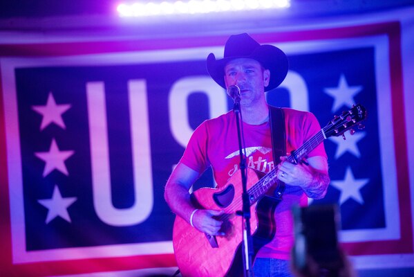 Country Music Singer Craig Campbell performs for service members during the USO Holiday Tour at Al-Udeid Air Base, Qatar, Dec. 6, 2016. Marine Gen. Joseph F. Dunford, Jr., chairman of the Joint Chiefs of Staff, along with USO entertainers, visited service members who are deployed from home during the holidays at various locations across the globe.  This year’s entertainers included actors Chris Evans, actress Scarlett Johansson, NBA Legend Ray Allen, 4-time Olympic Medalist Maya DiRado, Country Music Singer Craig Campbell, and mentalist Jim Karol. (DoD photo by Navy Petty Officer 2nd Class Dominique A. Pineiro)
