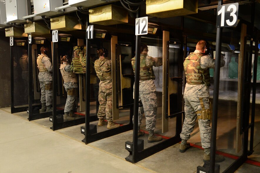 U.S. service members prepare to shoot M9 pistols at the 20th Security Forces Squadron Combat Arms Training and Maintenance range on Shaw Air Force Base, S.C., Dec. 7, 2016. CATM gives Team Shaw members the opportunity to practice shooting and qualify on different types of firearms such as an M9, M4 carbine and M16 rifle in order to remain combat ready at all times. (U.S. Air Force photo by Airman 1st Class BrieAnna Stillman) 