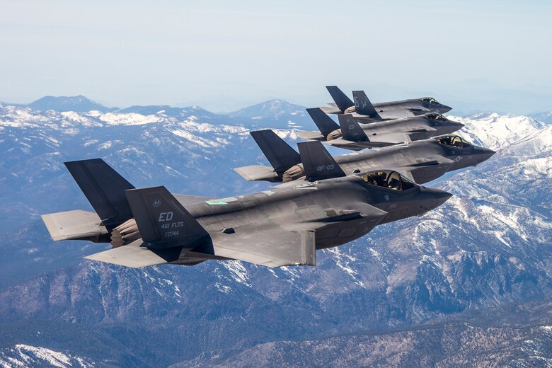 Flocking together: Three F-35As and an F-35C are pictured with the Sierra Nevada Mountains in the background during a recent four-ship test sortie conducted by the 461st Flight Test Squadron. Testing is done to ensure data is shared appropriately and accurately between aircraft. (Courtesy photo by Darin Russell/Lockheed Martin)