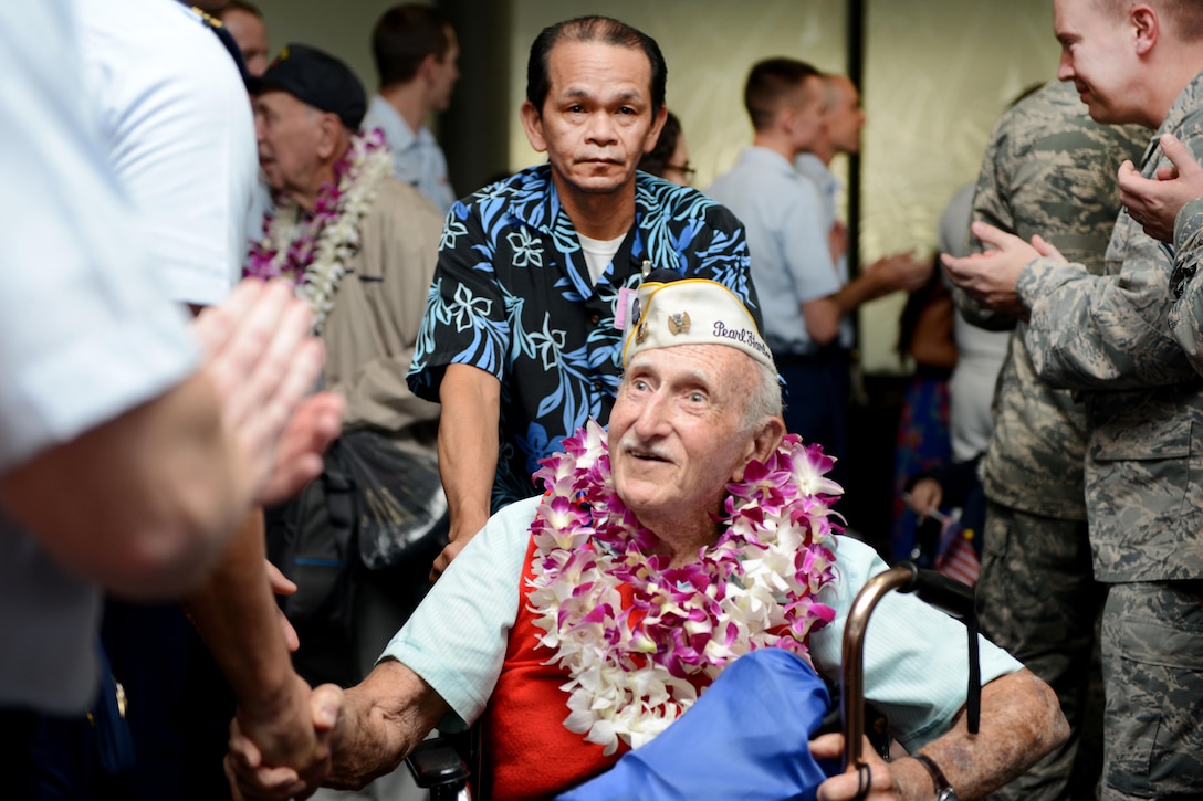 A Pearl Harbor survivor is greeted by service members after his arrival from Los Angeles at the Honolulu International Airport, Dec. 3, 2016. Coast Guard photo by Petty Officer 2nd Class Tara Molle 