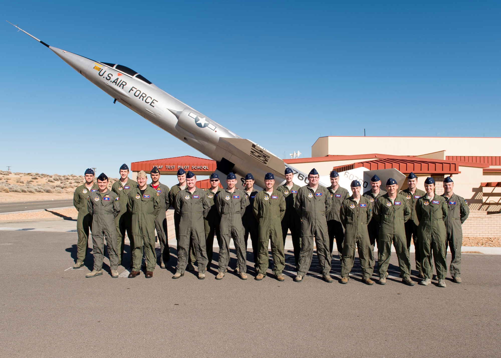 United States Air Force Test Pilot School Class 16A poses in front of the NF-104 display in front of the school house. USAF TPS Class 16A graduated Dec. 9 sending 20 new aviators into the flight test world. (U.S. Air Force photo by Ethan Wagner)
