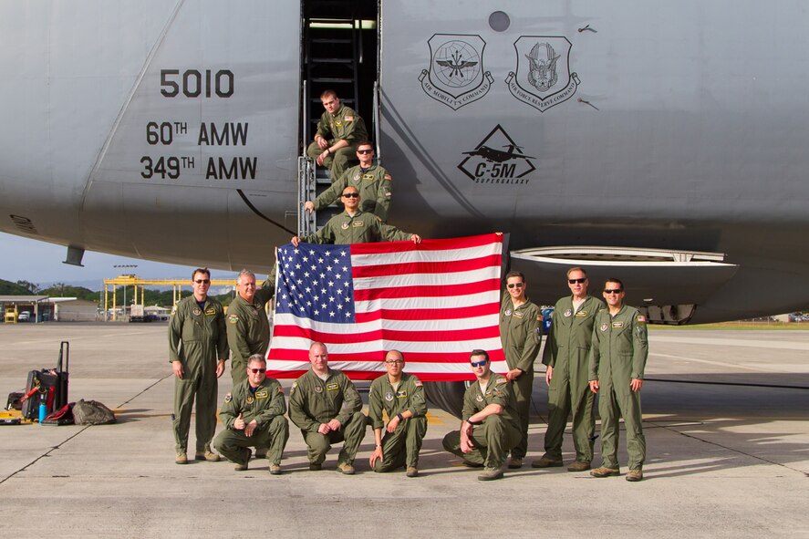 A 312th Airlift Squadron aircrew from Travis Air Force Base, Calif., displays "Old Glory" upon delivering the flag to Joint Base Pearl Harbor-Hickam, Hawaii, Dec. 2, 2016.
Master Sgt. Steve Burke, an Air Force Reserve loadmaster, cared for the flag during its long journey from Travis to the USS Arizona Memorial, where it flew during a Dec. 7, 2016 commemoration ceremony on the 75th anniversary of the Japanese attack on Pearl Harbor. The flight was a regularly scheduled training mission, which allowed the Citizen Airmen to help get the falg to Hawaii in time for the ceremony. (Courtesy photo MSgt Steve Burke)