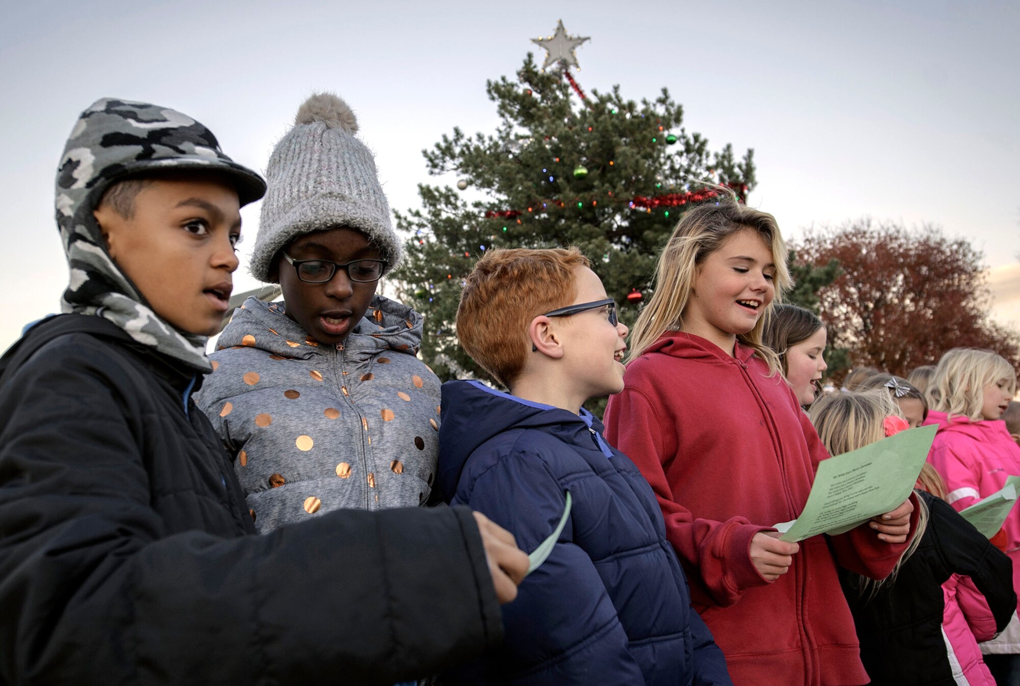 Eisenhower Elementary School students entertain the on-base crowd with holiday songs at Vance Air Force Base, Oklahoma, Sept. 5. Team Vance formally marked the beginning of the holiday season with a tree lighting and community get-together. (U.S. Air Force photo by David Poe)