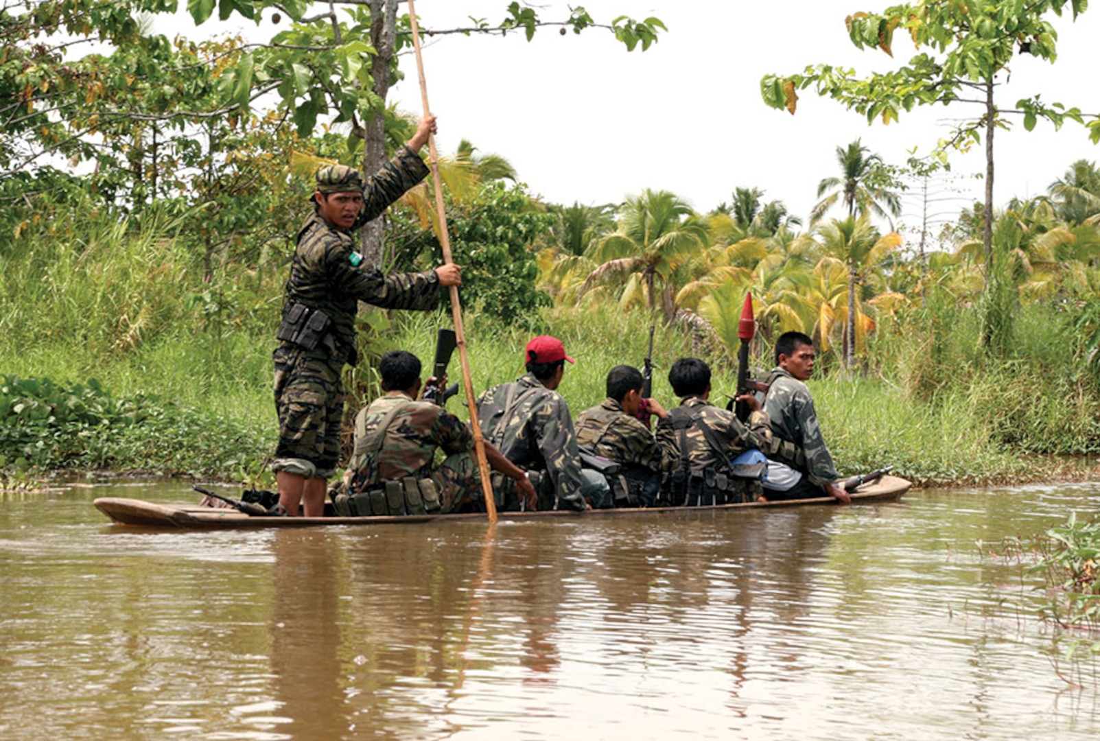 Moro Islamic Liberation Front members travel down a river in Maguindanao, Philippines.