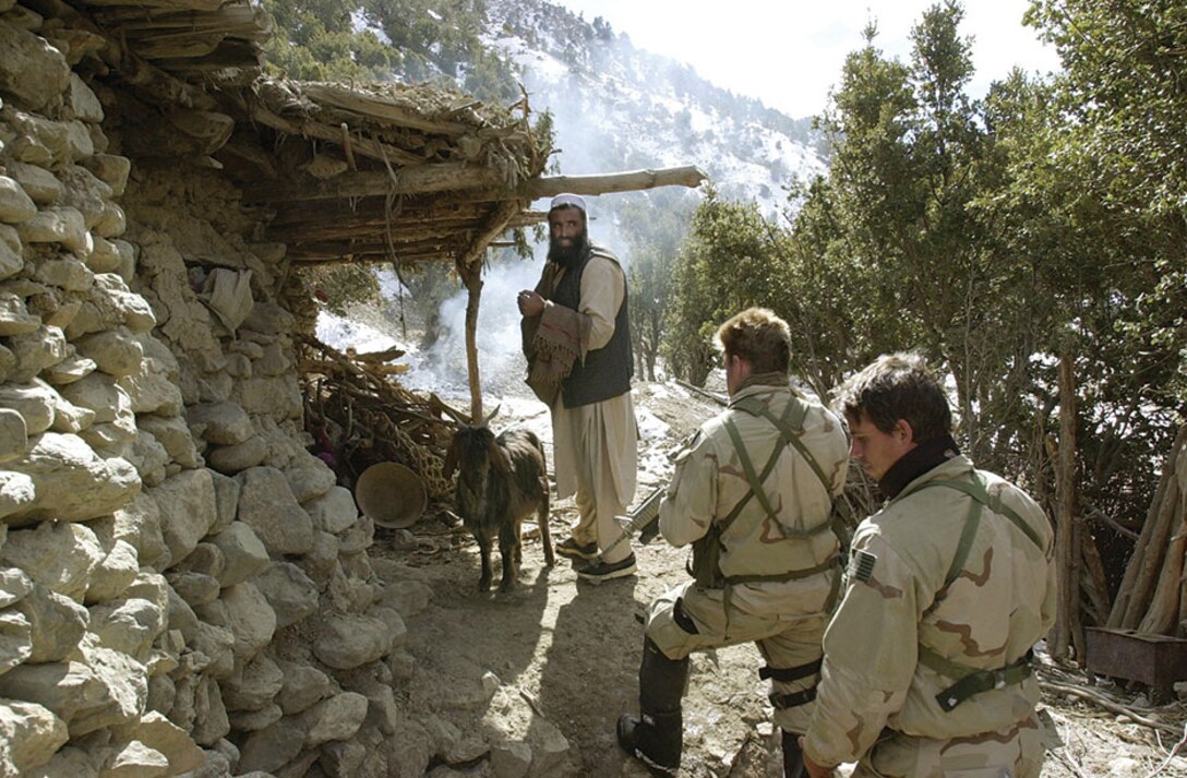 U.S. Navy Seal’s search for al-Qaida and Taliban while conducting a Sensitive Site Exploitation mission in the Jaji Mountains, Jan. 12, 2002.