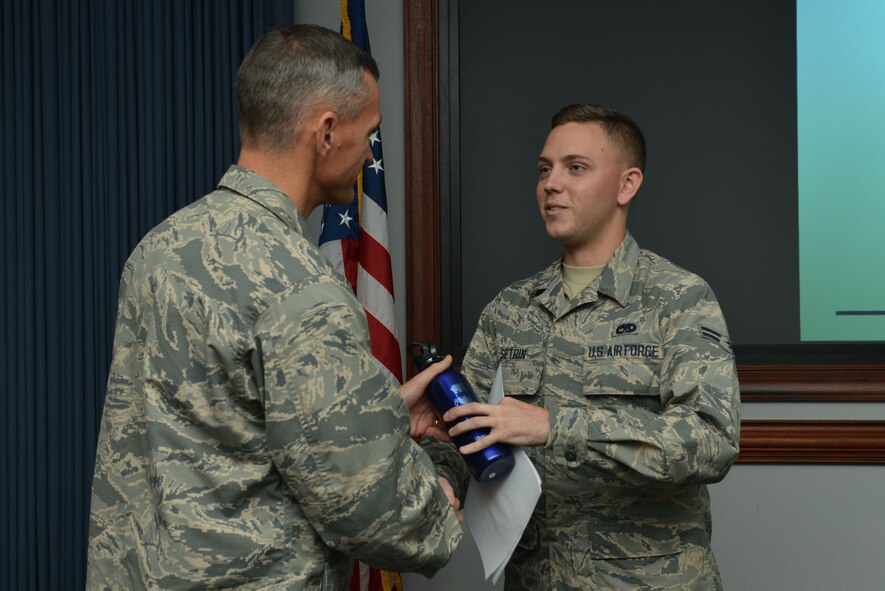 U.S. Air Force Airman 1st Class Andrew Setrin, 20th Component Maintenance Squadron aerospace propulsion apprentice, is recognized by Col. Daniel Lasica, 20th Fighter Wing commander, as the Shaw Weasel of the Week at Shaw Air Force Base, S.C., Dec. 7, 2016. Setrin was recognized as a sharp Airman who demonstrates outstanding professionalism and proficiency in his craft. (U.S. Air Force photo by Airman 1st Class Destinee Sweeney)