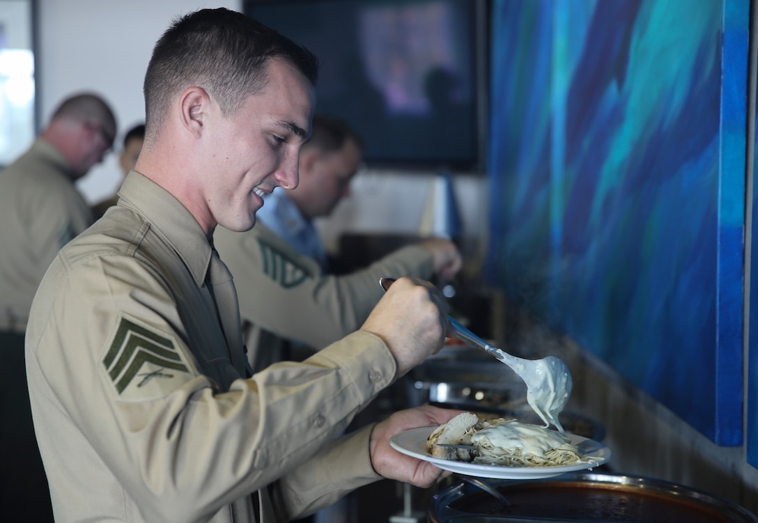 Sgt. Timothy Pattison makes his plate during a luncheon dedicated to the nominees of the Service Persons of the Quarter Award at the Boathouse in Beaufort, N.C., Nov. 15, 2016. Pattison earned this award for going above and beyond while volunteering in the local Carteret County community. Members of the U.S. Coast Guard, U.S. Marine Corps and U.S. Army Reserves gathered to honor their selected service members who were chosen for the award.  Pattison is an automotive maintenance technician for Marine Unmanned Aerial Vehicle Squadron 2, Marine Aircraft Group 14, 2nd Marine Aircraft Wing. (U.S. Marine Corps photo by Lance Cpl. Cody Lemons/Released)    