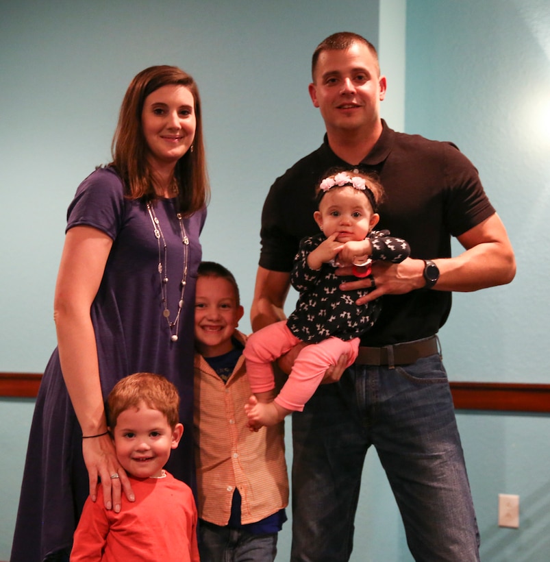 Sgt. Robert Newborg and his family pose for a photo after receiving the Military Family of the Quarter award in Havelock, N.C., Oct. 25, 2016. The award is given to the military family that has most positively impacted the local community over the past quarter. The Newborg’s donated and volunteered time and energy to the community by working with organizations such as the Knights of Columbus and a local elementary school. Newborg is a cryptologic equipment instructor at the Center of Naval Aviation Technical Training aboard Marine Corps Air Station Cherry Point, N.C. (U.S. Marine Corps photo by Lance Cpl. Cody Lemons/Released)