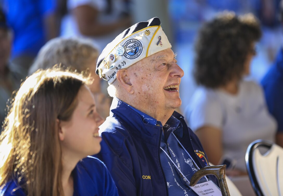 Former U.S. Navy Louis Conter, a USS Arizona survivor, listens to the U.S. Marine Corps Forces, Pacific Band perform at the USS Arizona Memorial Visitor Center, Hawaii, Dec. 6, 2016. The concert was held for civilian and military veterans visiting the memorial. The U.S. military, National Park Service, and State of Hawaii are jointly commemorating the 75th anniversary of the Dec. 7, 1941 attacks on Pearl Harbor and Oahu. (U.S. Marine Corps photo by Cpl. Wesley Timm/Released)