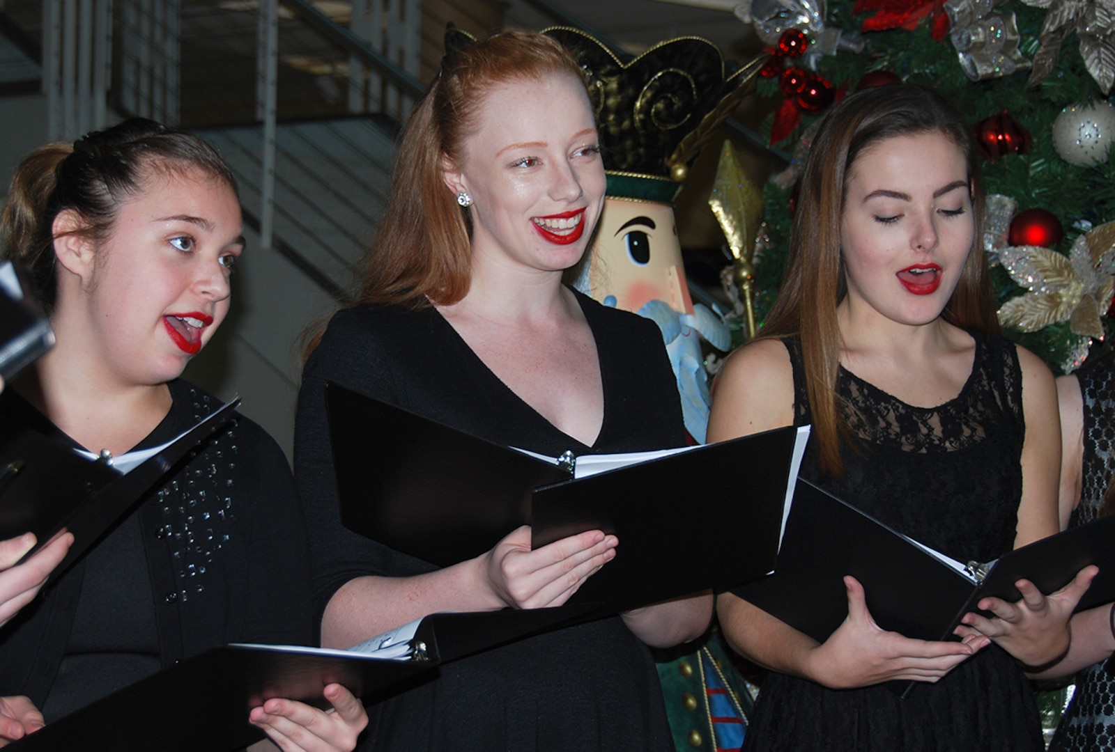Hannah Weilminster, Cayli Dobbs and Shannon O’Shaughnessy from the Metropolitan School of the Arts Academy sing “Gloria in Excelsis Deo” during the annual McNamara Headquarters Complex tree lighting ceremony Dec. 7.