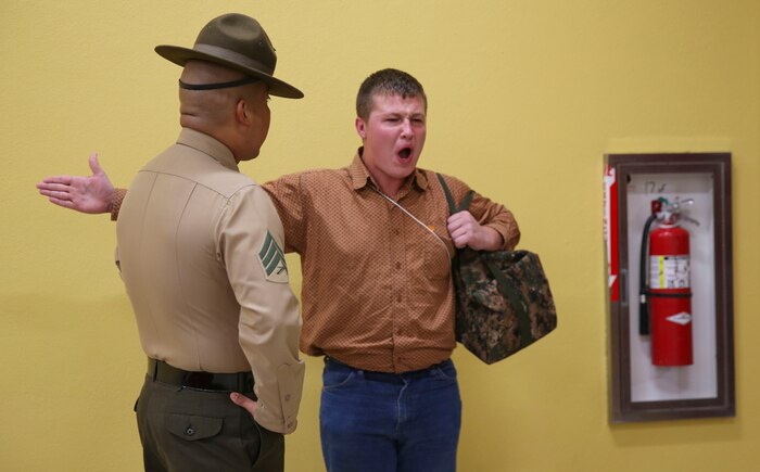 Sergeant David Alvarado, drill instructor, Receiving Company, Support Battalion, instructs a recruit to respond louder during receiving at Marine Corps Recruit Depot San Diego, Dec. 5. Although recruits are confused and disoriented during this portion of training, the chaos serves a purpose during the transformation from civilian to Marine. Annually, more than 17,000 males recruited from the Western Recruiting Region are trained at MCRD San Diego. Delta Company is scheduled to graduate March 3.