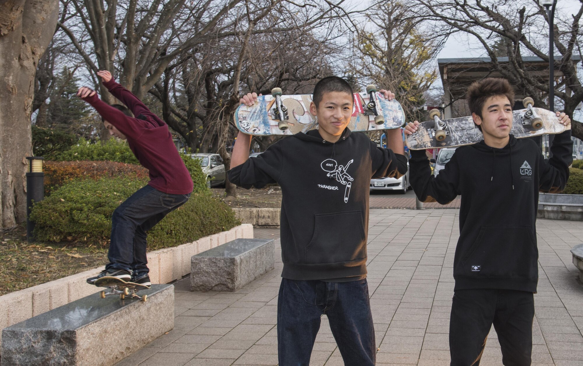 Japanese nationals stand with their skateboards as their friend performs a grind in Misawa City, Japan, Nov. 19, 2016. With a population of approximately 39,000 people, Misawa offers opportunities to meet and interact with different people. Carrying a Japanese dictionary, notepad, pen and a camera is a way to start socializing with locals. (U.S. Air Force photo by Airman 1st Class Sadie Colbert)