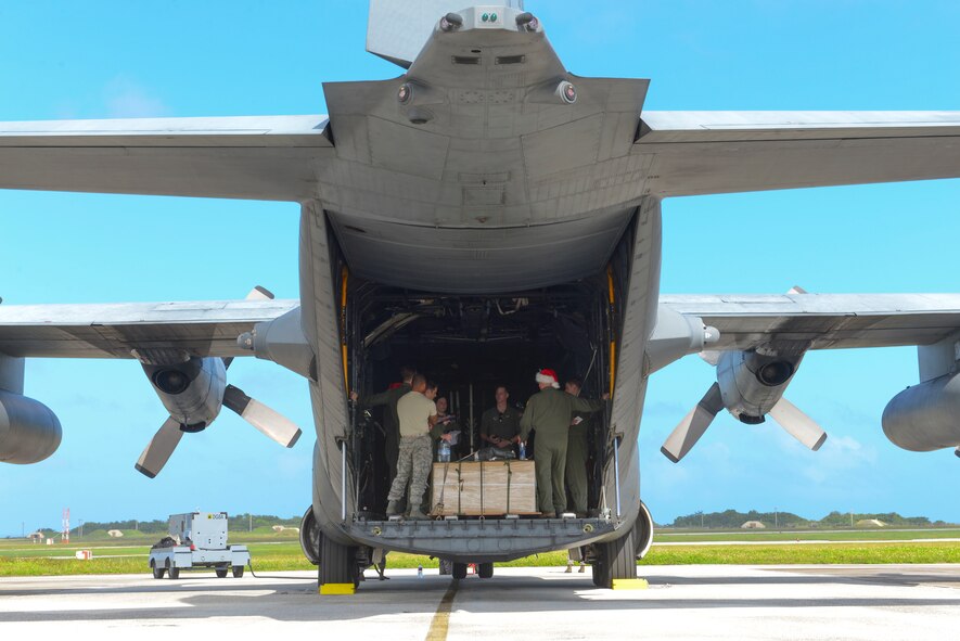 Aircrew from the 36th Airlift Squadron hold a preflight briefing aboard a C-130 H during Operation Christmas Drop at Andersen Air Force Base, Guam, Dec 5, 2016. The crew performed a bundle drop to practice for upcoming drops over the Micronesian Islands. The bundles, filled with donated goods and supplies, provide vital Airlift training for air crews and all other participants. (U.S. Air Force photo by Senior Airman Elizabeth Baker/Released)