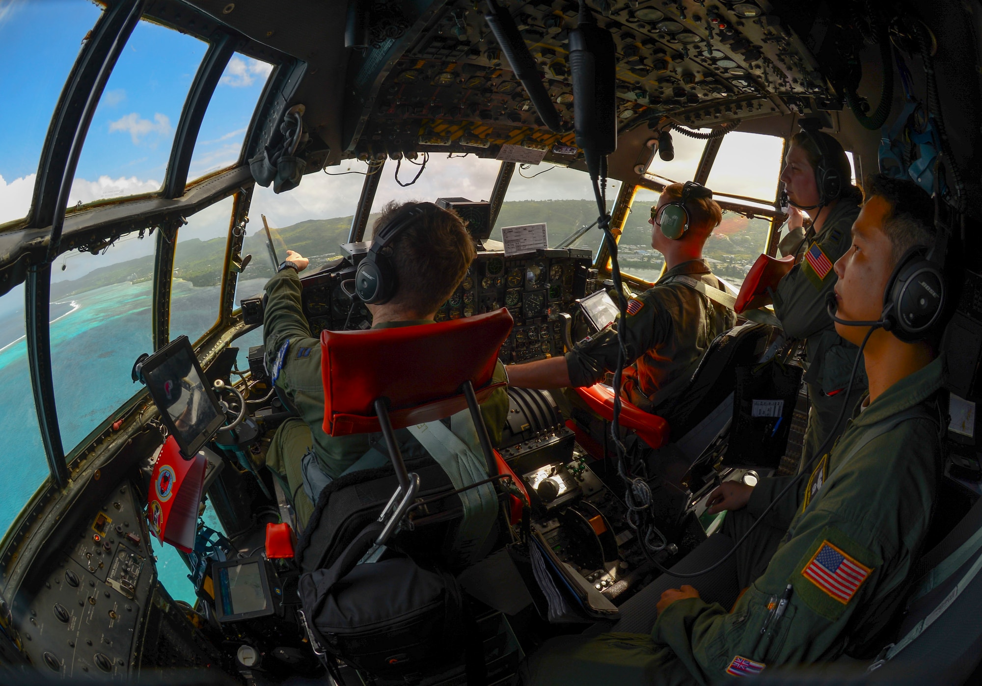 Air Crew aboard a C-130 H assigned to the 36th Airlift Squadron circle a Micronesian Island Dec. 5, 2016. The crew were practicing air drop procedures during Operation Christmas Drop. Each year OCD provides aid to over 30,000 islanders in Chuuk, Palau, Yap, Marshall Islands and Commonwealth of the Northern Mariana Islands. (U.S. Air Force photo by Senior Airman Elizabeth Baker/Released)